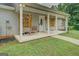 Charming front porch with inviting seating, decorative shutters, and seasonal decor on the front door at 527 Malcom Rd, Covington, GA 30014