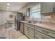 Well-appointed kitchen with stainless steel appliances and light green cabinets at 527 Malcom Rd, Covington, GA 30014