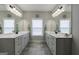 Bright bathroom features dual sinks, white cabinetry and tile floors at 3018 Patriots Square, Marietta, GA 30064