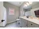 Well-lit bathroom with white vanity, tile floors, and shower with curtain at 3018 Patriots Square, Marietta, GA 30064
