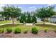 Well-maintained community park featuring two benches, green grass, lovely flowering trees, and landscaping at 3018 Patriots Square, Marietta, GA 30064