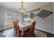 Dining room with a large window, stylish light fixture, and seating for six at 3018 Patriots Square, Marietta, GA 30064