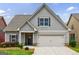 Charming home with a two-car garage, grey siding and manicured landscaping at 3018 Patriots Square, Marietta, GA 30064