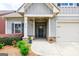 Inviting front porch with stone accents, decorative planters, and a stylish front door at 3018 Patriots Square, Marietta, GA 30064