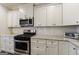Kitchen features granite countertops, stainless steel appliances and white cabinetry at 3018 Patriots Square, Marietta, GA 30064