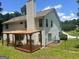 A beautiful backyard with a custom-built pergola and patio area providing comfortable outdoor seating at 4489 Northwind Dr, Ellenwood, GA 30294