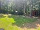 View of the private backyard with a basketball hoop and shed at 4489 Northwind Dr, Ellenwood, GA 30294