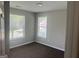 Well-lit bedroom featuring carpet, two windows, and neutral wall color at 4489 Northwind Dr, Ellenwood, GA 30294