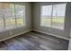 Cozy bedroom with natural light, neutral paint and modern gray flooring at 4489 Northwind Dr, Ellenwood, GA 30294
