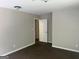 Bedroom features neutral paint, trim and carpeting with an open doorway to hallway at 4489 Northwind Dr, Ellenwood, GA 30294