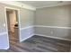 Inviting dining area with chair rail detail and modern grey flooring at 4489 Northwind Dr, Ellenwood, GA 30294
