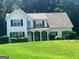 Charming two-story home with a well-manicured lawn and inviting curb appeal nestled among mature trees at 4489 Northwind Dr, Ellenwood, GA 30294