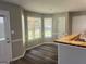 A cozy kitchen nook with large windows, wooden floors, and a breakfast bar at 4489 Northwind Dr, Ellenwood, GA 30294