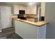 Bright kitchen with white cabinets, butcher block countertops and a breakfast bar, offering a cozy space at 4489 Northwind Dr, Ellenwood, GA 30294