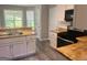 Well-lit kitchen boasts modern appliances, butcher block counters and ample cabinet space at 4489 Northwind Dr, Ellenwood, GA 30294