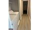 Bright laundry room features washer and dryer with hallway leading to the door ahead at 4489 Northwind Dr, Ellenwood, GA 30294