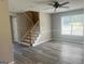 Bright living room with large window, stairs, and chair rail molding at 4489 Northwind Dr, Ellenwood, GA 30294