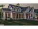 Charming farmhouse exterior featuring rocking chairs on the front porch at 120 Godby Dr, Fayetteville, GA 30215