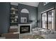 Stylish living room with a cozy fireplace, modern decor, and large windows for natural light at 120 Godby Dr, Fayetteville, GA 30215