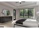 Main bedroom with a large window, tray ceiling and a dresser at 120 Godby Dr, Fayetteville, GA 30215