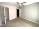 Bedroom with neutral carpet, a ceiling fan, and an open closet for storage at 2841 Heritage Ln, Morrow, GA 30260
