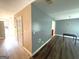 Open floor plan showing neutral paint colors, vinyl floors, and a pendant light fixture at 2841 Heritage Ln, Morrow, GA 30260