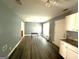 Spacious dining area with dark vinyl floors, a pendant light, and neutral paint at 2841 Heritage Ln, Morrow, GA 30260