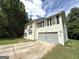 View of a two-story house featuring a two-car garage and a driveway at 2841 Heritage Ln, Morrow, GA 30260