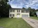 Charming two-story home with a well-maintained lawn and attached two-car garage at 2841 Heritage Ln, Morrow, GA 30260