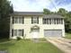 Charming two-story home with a well-maintained lawn and attached two-car garage at 2841 Heritage Ln, Morrow, GA 30260