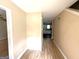 Hallway featuring hardwood floors leading into the house, with the kitchen visible at 2841 Heritage Ln, Morrow, GA 30260