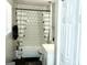 Modern bathroom with a white tile shower, stylish curtain, and updated fixtures at 3253 Blackfoot Ln, Rex, GA 30273