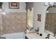 Well-lit bathroom with a tiled shower-tub combination, vanity, and decorative mirror at 3253 Blackfoot Ln, Rex, GA 30273