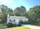 Charming single-story home featuring a manicured front yard, gray siding, and classic black shutters at 3253 Blackfoot Ln, Rex, GA 30273