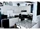 Cozy kitchen featuring gray cabinets, granite countertops, and modern appliances for efficient meal preparation at 3253 Blackfoot Ln, Rex, GA 30273