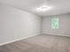 Neutral bedroom with a window offering natural light; perfect blank canvas at 2039 Faith Cv, Atlanta, GA 30349