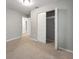 Cozy bedroom features neutral walls and carpet, a closet, and neutral paint at 2039 Faith Cv, Atlanta, GA 30349