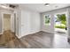 Bright bedroom with gray floors, closet, and a window offering natural light and outdoor views at 2039 Faith Cv, Atlanta, GA 30349