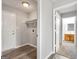 Hallway view showcasing gray floors, fresh paint, and a glimpse of a bathroom with wood vanity at 2039 Faith Cv, Atlanta, GA 30349