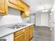 Open concept kitchen boasts wood cabinets, gray counters, a view of the living area and modern flooring at 2039 Faith Cv, Atlanta, GA 30349