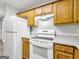 Charming kitchen showcases white appliances, wooden cabinetry, and neutral countertops for a classic appeal at 2039 Faith Cv, Atlanta, GA 30349