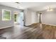Inviting living room with gray flooring, an open doorway to garage, neutral paint, and modern lighting at 2039 Faith Cv, Atlanta, GA 30349