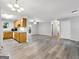 Spacious living room with gray wood-look floors, kitchen, and access to the outdoors through French doors at 2039 Faith Cv, Atlanta, GA 30349