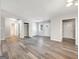 Bright living room featuring modern gray flooring, neutral walls, and ample natural light through the front door at 2039 Faith Cv, Atlanta, GA 30349