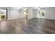 Open-concept floor plan with gray wood-look floors leading to the kitchen and French doors at 2039 Faith Cv, Atlanta, GA 30349