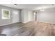 Neutral living room with gray flooring, fresh paint, natural light from window and entryway at 2039 Faith Cv, Atlanta, GA 30349