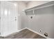 Mud room featuring wood floors, a white exterior door, and a shelf for storage solutions at 2039 Faith Cv, Atlanta, GA 30349