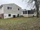 View of backyard featuring multi-story home with screened-in porch, ample space and mature trees at 5793 Springfield Pl, Ellenwood, GA 30294