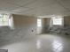 Unfinished basement featuring decorative marble-style wainscoting, drop ceiling and tile floors offers potential for customization at 5793 Springfield Pl, Ellenwood, GA 30294