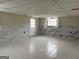 The finished basement features tile flooring, decorative wall paneling, and natural light from a window at 5793 Springfield Pl, Ellenwood, GA 30294
